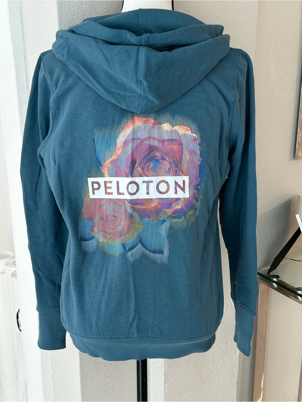 Peloton Teal Hoodie with Multicolor Floral Back Logo